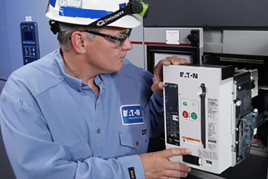 An Eaton inspector visually examines a piece of electrical distribution equipment