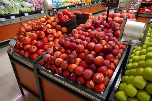 A grocery store display of red apples. Current's TriGain LED color rendering makes their color more vibrant.
