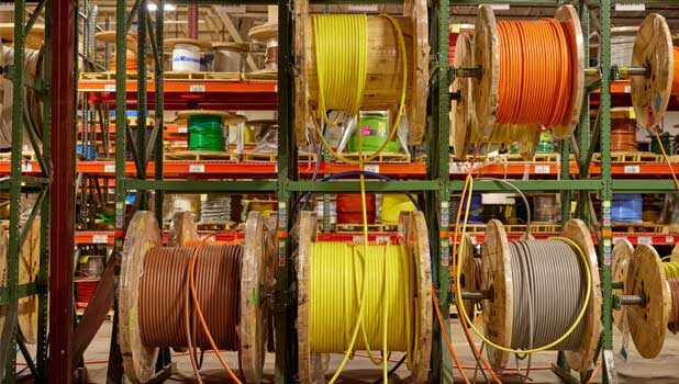 Spools of electrical wire hanging up at Loeb Electric's main HQ wire room