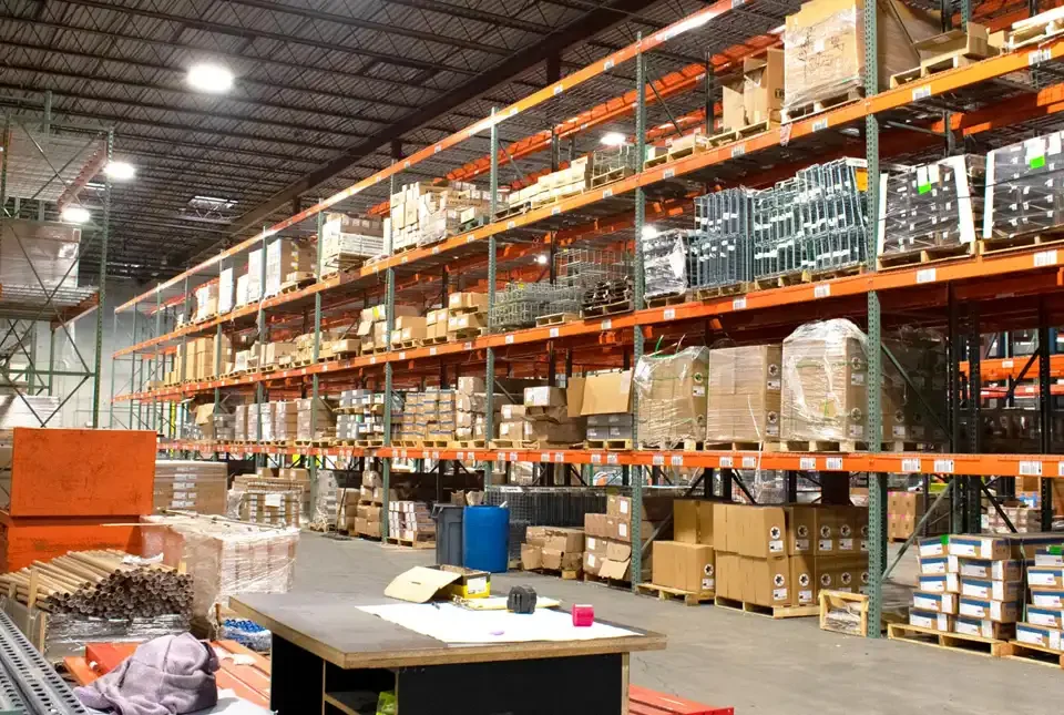 A view of a filled warehouse with wrapped pallets of electrical supplies and strut